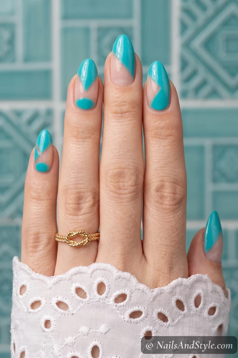 Geometric turquoise nail art with bare nail negative space sections