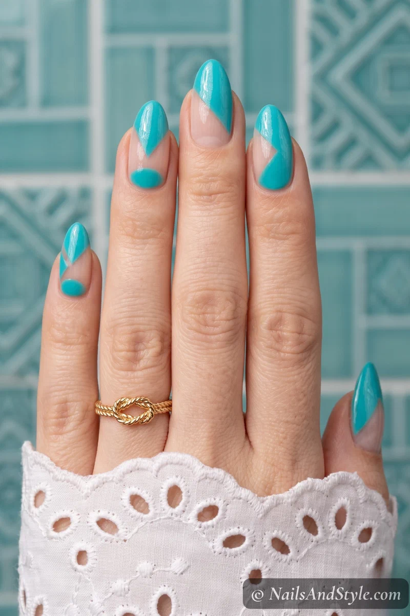 Geometric turquoise nail art with bare nail negative space sections