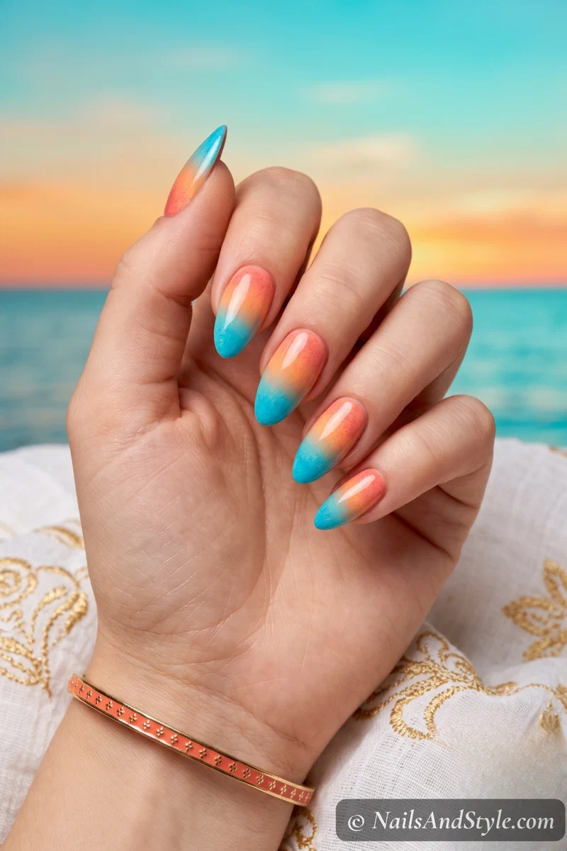 Gradient nails blending warm coral at cuticle to turquoise at tips