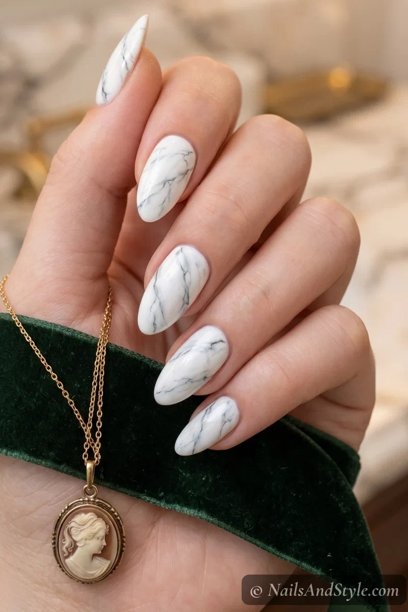 White marble effect nails with grey veining and glossy stone finish on medium almond nails