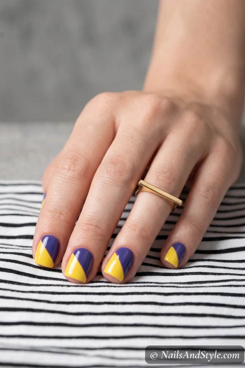 Yellow and blueberry half-and-half split nail design with clean diagonal line on short square nails