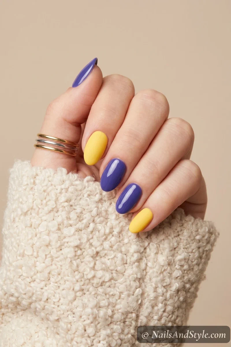 Matte yellow and glossy blueberry purple nails alternating textures on short almond nails