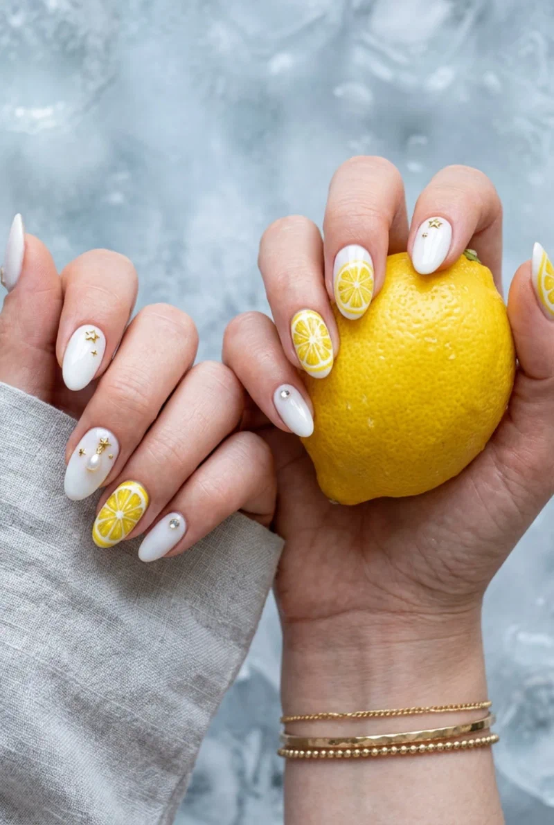 White nails with lemon slice nail art on accent nails