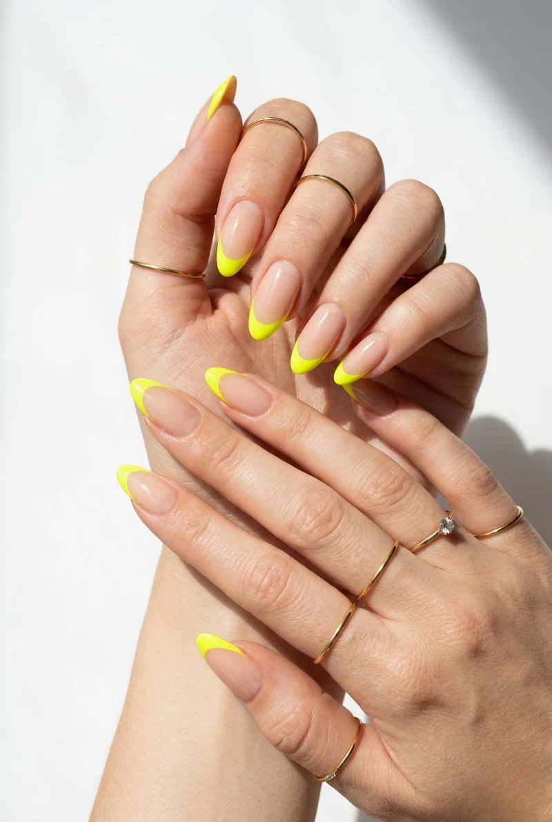 Neon yellow tipped nails on a nude base
