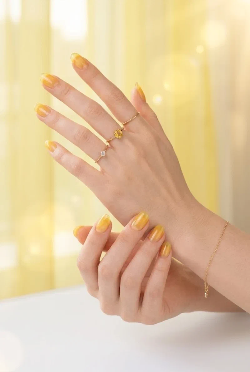 Sheer yellow jelly finish nails on rounded nail shape